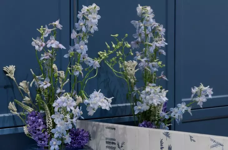 The area above the washbasin has been tiled with a floral pattern 