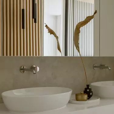 The bathroom uses a warm shade of wood