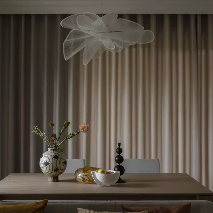 A large table and upholstered chairs create a dining area