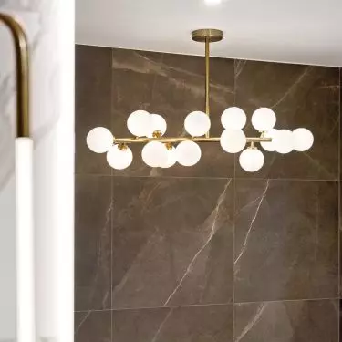A decorative lamp hangs over the bathtub