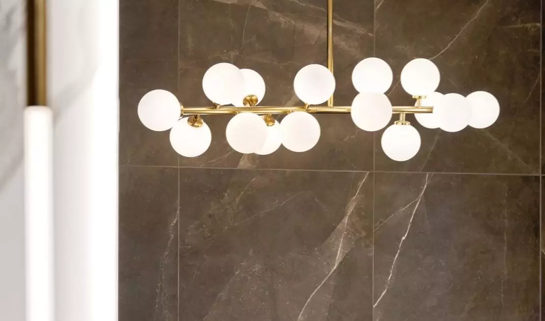 A decorative lamp hangs over the bathtub