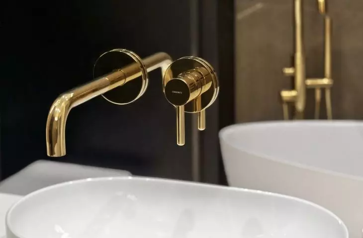 Gold bathroom faucets add an elegant touch to the interior