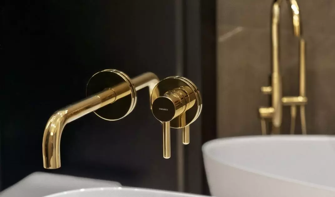 Gold bathroom faucets add an elegant touch to the interior