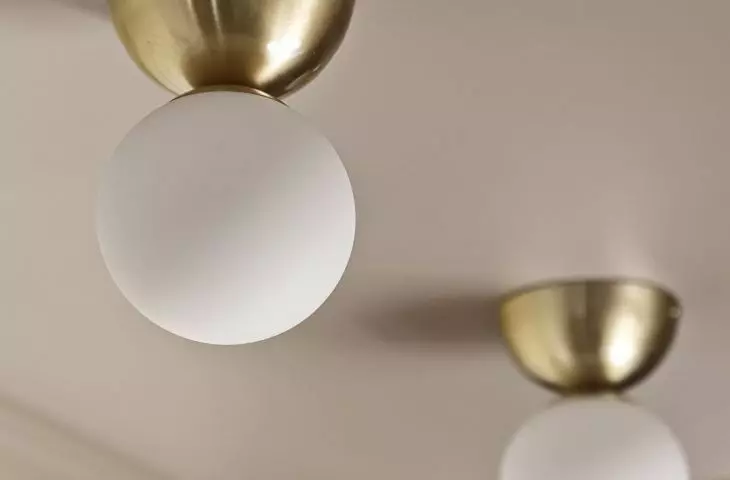 White and gold light fixtures add elegance to space