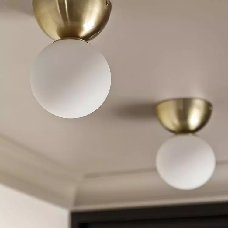 White and gold light fixtures add elegance to space