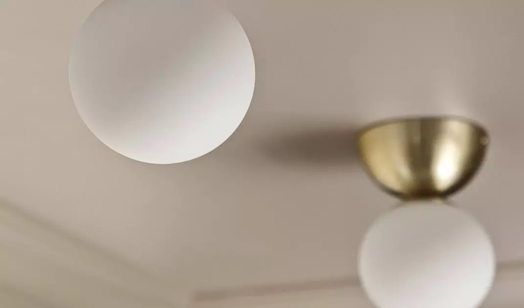White and gold light fixtures add elegance to space