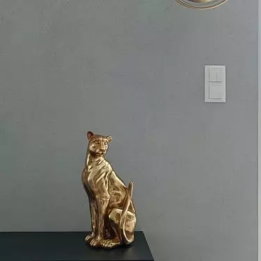 The subdued arrangement is complemented by gold accessories