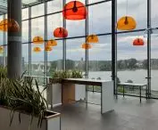 CH Malta w Poznaniu — opustoszały food court z widokiem na jezioro Malta i panoramę miasta z katedrą  