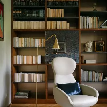 Part of the bookcase has sliding panels finished with a mirror