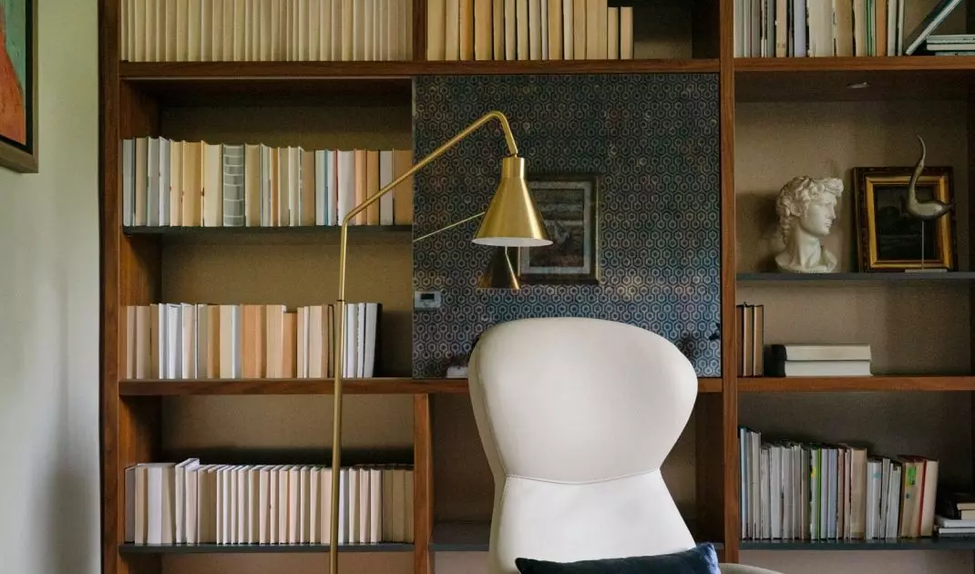 Part of the bookcase has sliding panels finished with a mirror