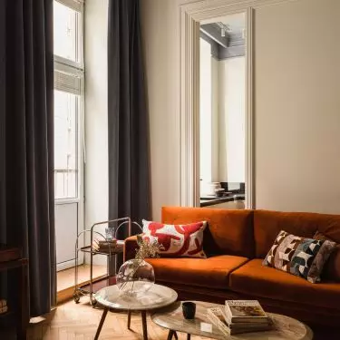 The kitchen is separated from the lounge area by a vertical window