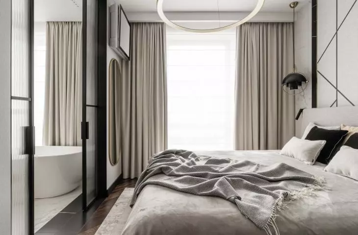 The bedroom is separated from the bathroom by a sliding door