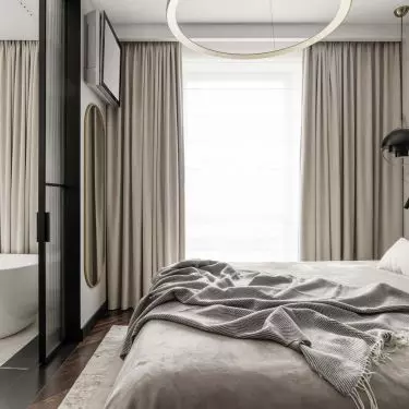The bedroom is separated from the bathroom by a sliding door