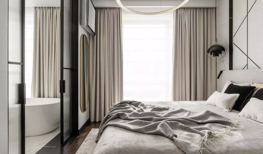 The bedroom is separated from the bathroom by a sliding door