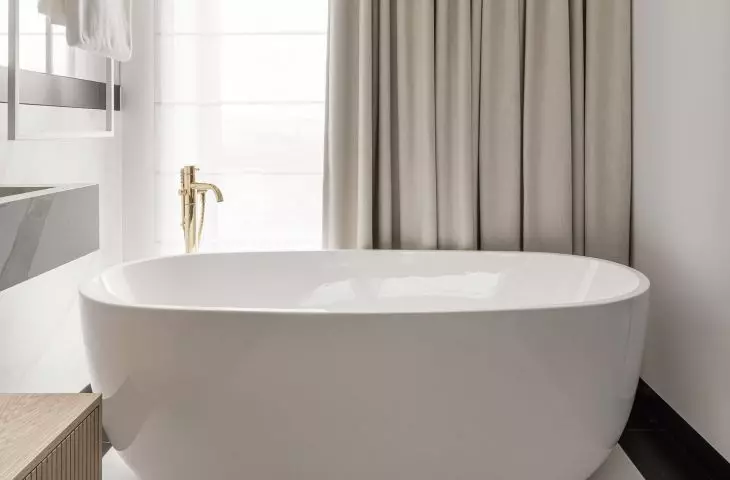The free-standing bathtub was placed next to the window