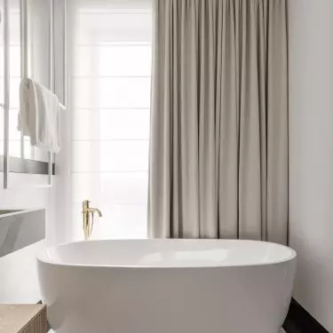 The free-standing bathtub was placed next to the window