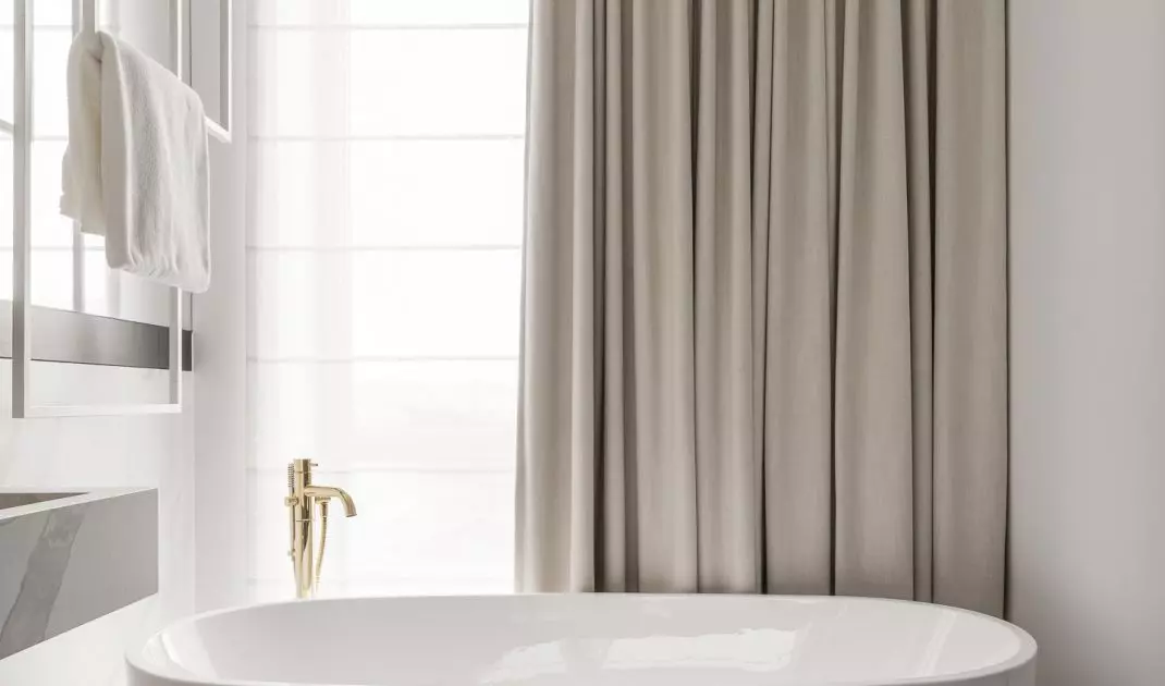 The free-standing bathtub was placed next to the window