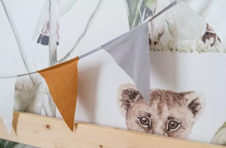 Wallpaper behind the bed shows animals