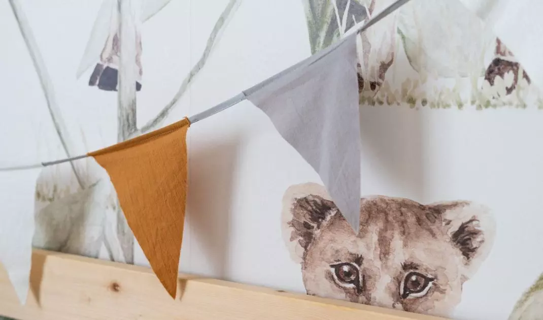 Wallpaper behind the bed shows animals