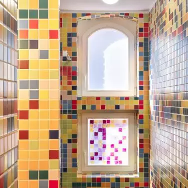 Colors taken from the murals were transferred to the mosaic in the bathroom