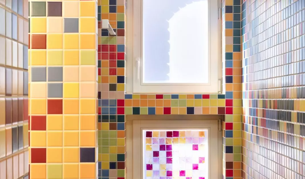 Colors taken from the murals were transferred to the mosaic in the bathroom