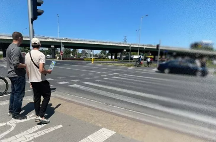 Photo of street and pedestrian crossing - an exclusionary, noisy space with no place to rest