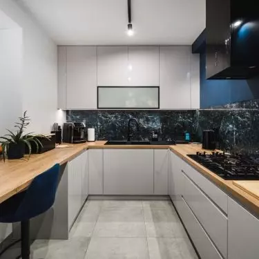 The gray fronts of the built-ins blend with the granite walls, continuing the color palette of the entire interior