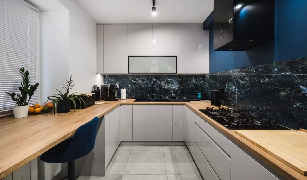 The gray fronts of the built-ins blend with the granite walls, continuing the color palette of the entire interior