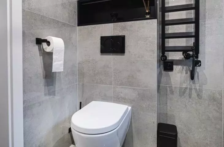 The enclosure above the toilet provides storage space