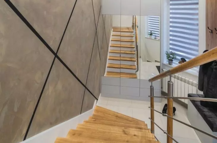 At the confluence of the stairs is a closet with mirrored fronts