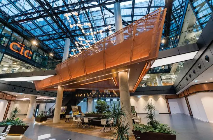 Copper-colored braided mesh wall cladding and balustrades at VARSO TOWER, architect: HRA Architects