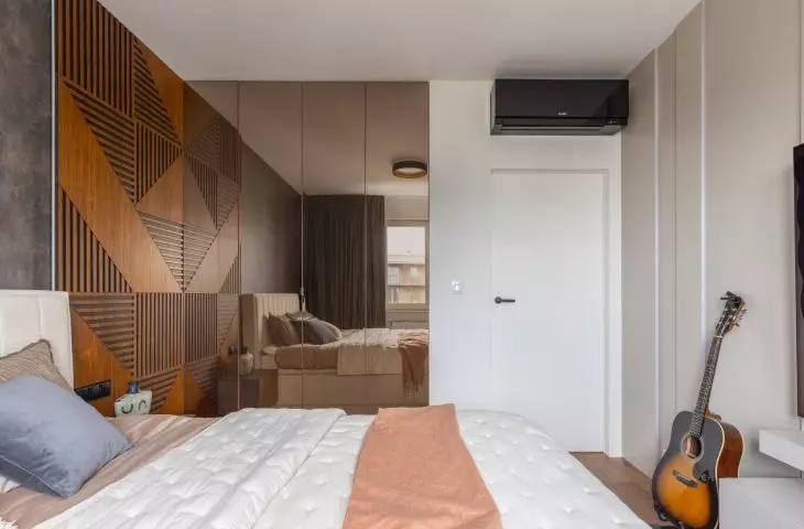 The decoration of the bedroom is the wall behind the bed