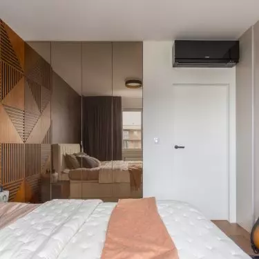 The decoration of the bedroom is the wall behind the bed