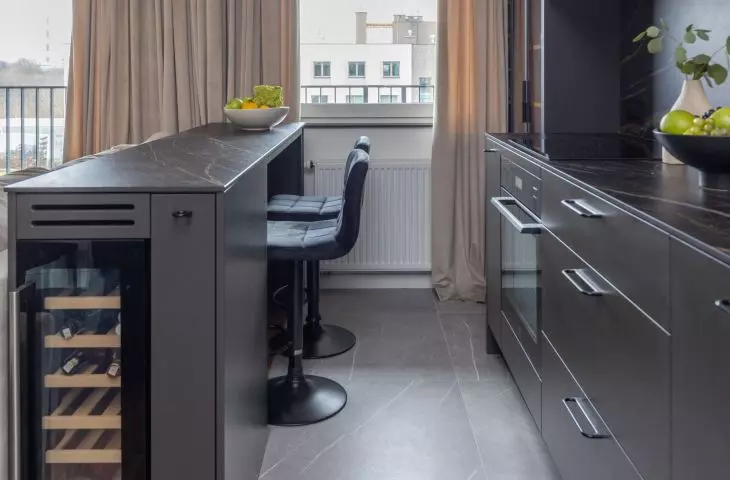 The kitchen island is designed with a wine storage area