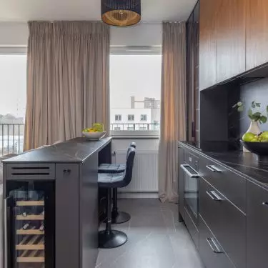 The kitchen island is designed with a wine storage area