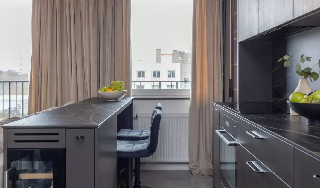 The kitchen island is designed with a wine storage area