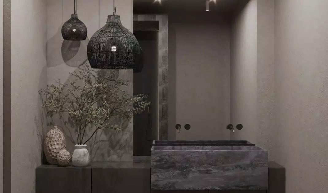 The bathroom is kept in dark colors