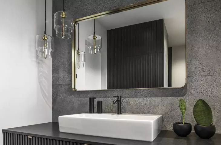 Decorating the bathroom are gold accents