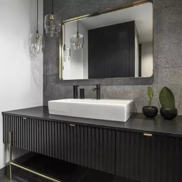 Decorating the bathroom are gold accents