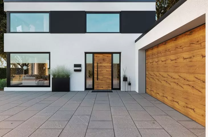 Sectional door with Duragrain Decoral surface matching the surface of the ThermoSafe entrance door