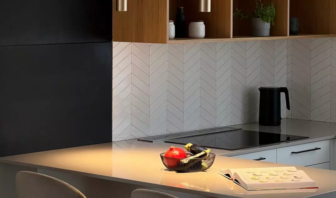 The wall was covered with glazed tiles arranged in a herringbone pattern