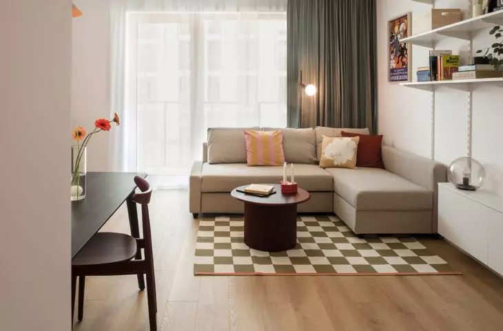 In the living room there is a corner sofa bed