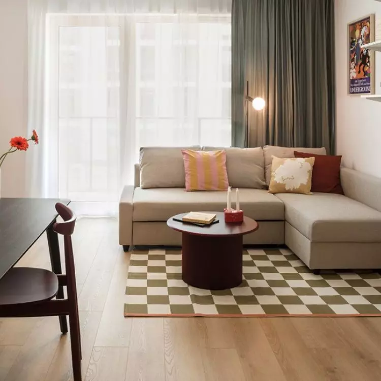 In the living room there is a corner sofa bed