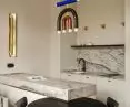 black table grows out of kitchen island