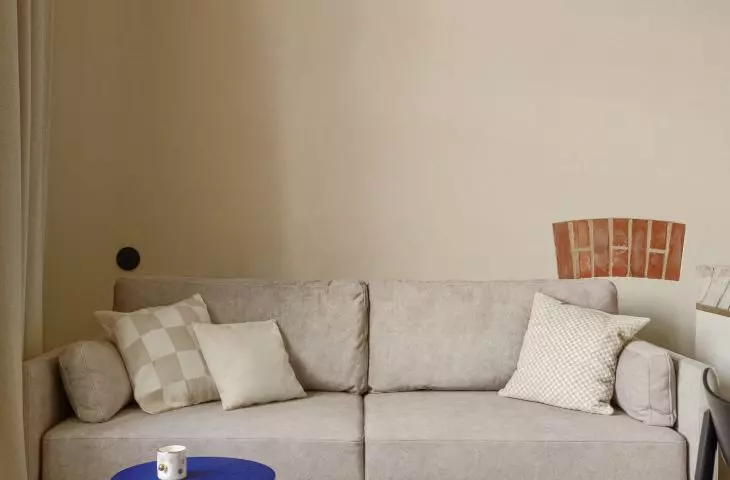 In both apartments, the architects exposed the rough walls of the former Polish House