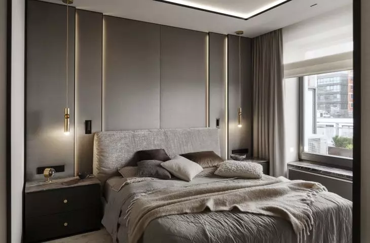The wall behind the bed was lined with upholstered panels