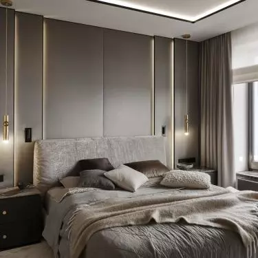 The wall behind the bed was lined with upholstered panels