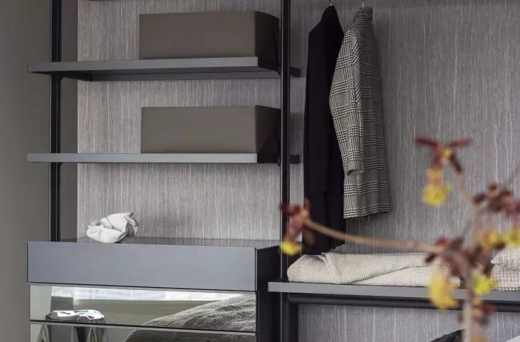 Open closet and mirrored fronts optically enlarge the bedroom