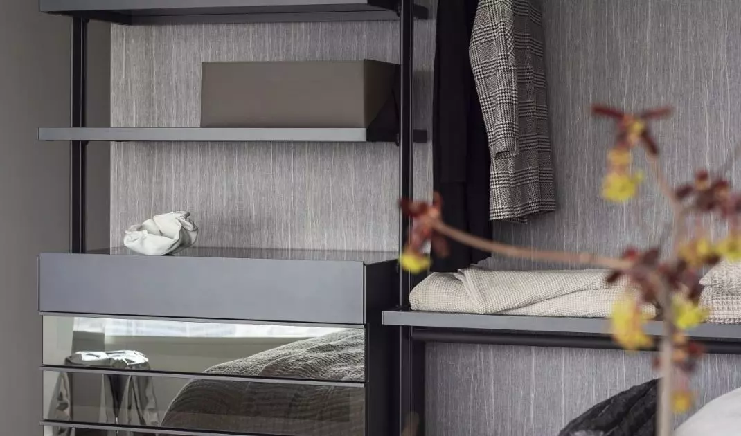Open closet and mirrored fronts optically enlarge the bedroom