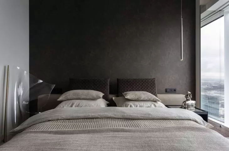 The wall behind the bed was lined with textile wallpaper